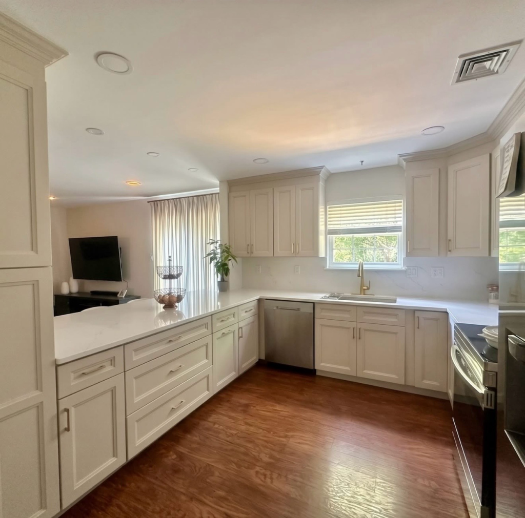 White kitchen cabinetry and countertop peninsula