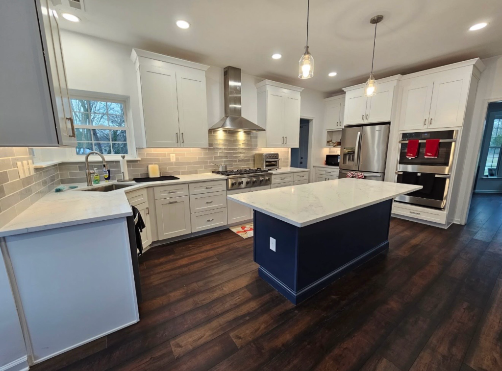 Kitchen island and white countertops with gray backsplash